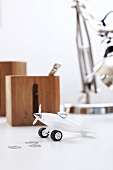 Toy airplane on table as paper weight