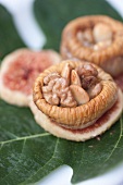 Close-up of hollowed figs with nuts in it on leaf
