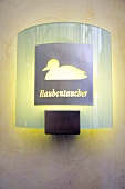 Close-up of wall lamp with grebe print in Hotel Ferry at Munkmarsch, Sylt, Germany