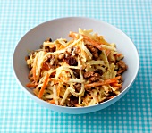 Celery salad with walnuts and raisins in bowl