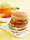 A homemade hamburger with tomatoes, lettuce and cucumber