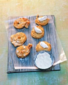 Apple fritters in peanut oil with mascarpone on baking sheet
