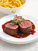 Venison with cranberry sauce on plate