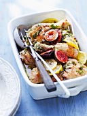 Lemon chicken with honey and figs in serving dish in summer kitchen