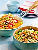 Pasta salad with chicken and couscous salad with chickpeas in bowls