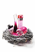 Close-up of pink perfume bottles in a nest