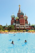 Tourists in pool with Hotel Kremlin Palace in background, Antalya, Turkey