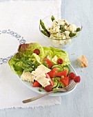 Vegetables salad with asparagus, cauliflower salad and camembert in serving dish