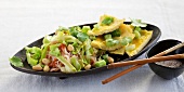 Rice noodle salad with cabbage and omelette in serving dish