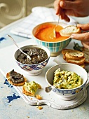 Three various dips in bowl served with slices of baguette, France