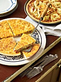 Quiche lorraine and pear and roquefort tart on plate, France