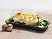 Potato and spinach gratin in serving dish