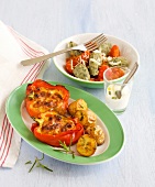 Stuffed peppers in serving dish with chard in bowl
