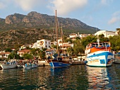 View of boats moored at harbour with mountains in background, Kas, Lycia, Antalya, Turkey