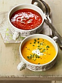 Tomato soup and pumpkin soup in two bowls, France