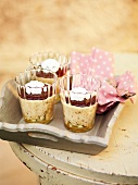 Chestnut mousse with chocolate sauce in three glasses on tray, France