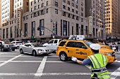Traffic police controlling traffic in front of Hotel New Yorker in New York, USA