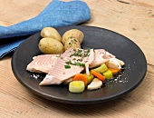 Salmon trout with potatoes and vegetables on plate