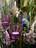 Close-up of plug votives in planters with flowers