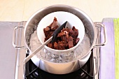 Bowl of chocolates in boiling water for preparation of desserts