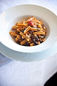 Close-up of pasta with olives in serving dish