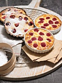 Four rice pudding with raspberry, cherry clafoutis in ramekins