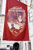 Flag with a restaurant name hanging outside St Peter Monastery in Salzburg, Austria