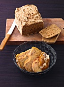 Country bread on wooden platform and potato bread in basket