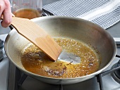 Hand stirring pan drippings in frying pan, step 4