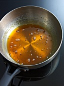 Boiled sugar and water in pan for preparation of caramel, step 4