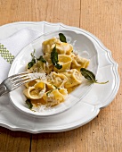 Tortellini with sage on oval plate