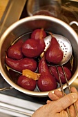 Pears being cooked in red wine