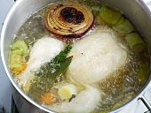 Boiling chicken with vegetables in pan for preparation of chicken stock, step 5
