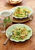 Cabbage salad garnished with mint on serving dish