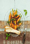 Roasted carrot salad with dried tomatoes, pesto and sesame seeds