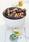 Lamb skewers and halloumi skewers on a barbecue