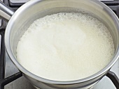 Close-up of cream being boiled in pan, step 1