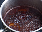 Close-up of mixture being boiled in pan for preparation of bound wild jus, step 3