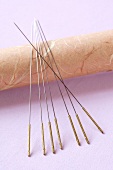 Close-up of acupuncture needles on purple background