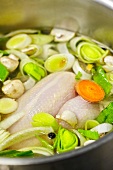 Close-up of poularde with vegetables in pot