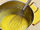 Close-up of congealed sauce being whisked in wok