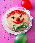 Clown cake with apple and marzipan dough on plate