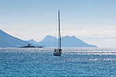 View of sea with sailboat and mountains in Croatia