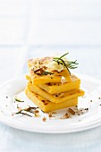 Polenta slices with pine nuts, rosemary and Parmesan