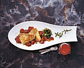 Cooked turbot with tomato juice in serving dish
