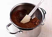 Close-up of tempering chocolate in casserole