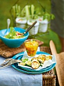 Zucchini with coriander chutney and melons on plate, garden kitchen