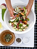 Vegetables being tossed in bowl