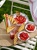 Sponge cake with strawberries on wooden board