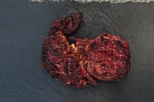 Close-up of roasted steak on black background